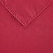 A hot pink rectangular polyester table cover with a corner.