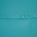 A close up of a teal blue fabric with a stitch along the edge.