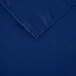 A folded royal blue rectangular cloth table cover with a square edge.