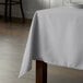 A rectangular table with a gray Intedge tablecloth.