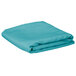 A folded teal rectangular cloth table cover.