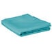 A folded teal square table cover on a white background.