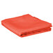 A folded orange Intedge square table cover.