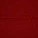 A close up of a red fabric table cover.