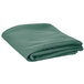 A folded green table cover on a white background.