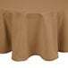 A beige Intedge round cloth table cover on a table.