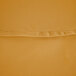 A close up of a gold polyester fabric with a hemmed edge.