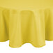 A yellow Intedge cloth table cover on a round table.