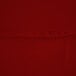 A close up of a red fabric table cover.