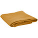 A folded gold table cover on a white background.