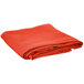 An orange folded hemmed cloth table cover.