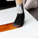 A hand using an Ateco round boar bristle pastry brush to paint brown sauce.