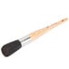 A round pastry brush with a wooden handle with white bristles.