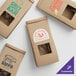 A brown Kraft paper bag with a window and customizable logo.
