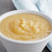 A bowl of Regal sweetened applesauce on a table.