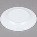 A white Minski melamine plate with a textured rim.