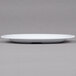 A white GET Centuria melamine plate with a rim on a grey surface.
