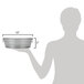 A woman holding an American Metalcraft galvanized metal tub with a handle.