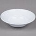 A white Minski melamine bowl with a textured rim.