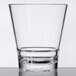 A close up of a clear GET Revo plastic rocks glass.