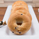 A row of bagels on a white Milano display tray.