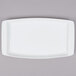 An Arcoroc white rectangular tray with a white rim.