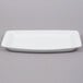 A white rectangular Arcoroc tray with a small rim.