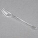 a clear plastic fork on a white surface