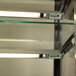 A close-up of a Delfield glass shelf with two lights on it.