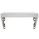 A silver rectangular shelf with holes on metal brackets.