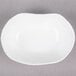 A 10 Strawberry Street bright white porcelain small elliptical dish with a small rim.