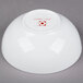 A white 10 Strawberry Street bone china bowl with red text on it.