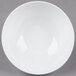 A white bowl with a white rim on a gray background.