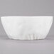 A white round porcelain bowl with a gray background.