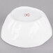 A white bowl with a red circle on it.