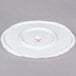 A bright white porcelain oval platter with a spiral cut edge.