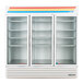 A white True refrigerated glass door merchandiser with shelves.