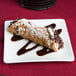 A chocolate covered pastry on a 10 Strawberry Street white square bone china plate.