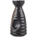 A black and white speckled stoneware sake bottle.