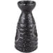 A black and white speckled stoneware sake bottle.