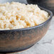 A 10 Strawberry Street Whittier stoneware bowl filled with rice on a marble surface.