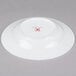 A white 10 Strawberry Street bone china wide rim soup bowl with a red logo.