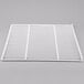 A white coated wire shelf with square holes.