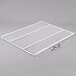 A white coated metal wire shelf with metal clips.