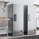 Two True T-12-HC reach-in refrigerators with white solid doors in a professional kitchen.