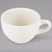 A white Tuxton Nevada china cup with a handle.