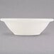 A white Tuxton Nevada fruit bowl with a narrow rim.