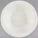 A white bowl with a white rim on a gray background.