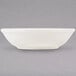 A white Tuxton eggshell china fruit dish.