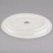 A white Tuxton china platter with a narrow rim and black text on it.